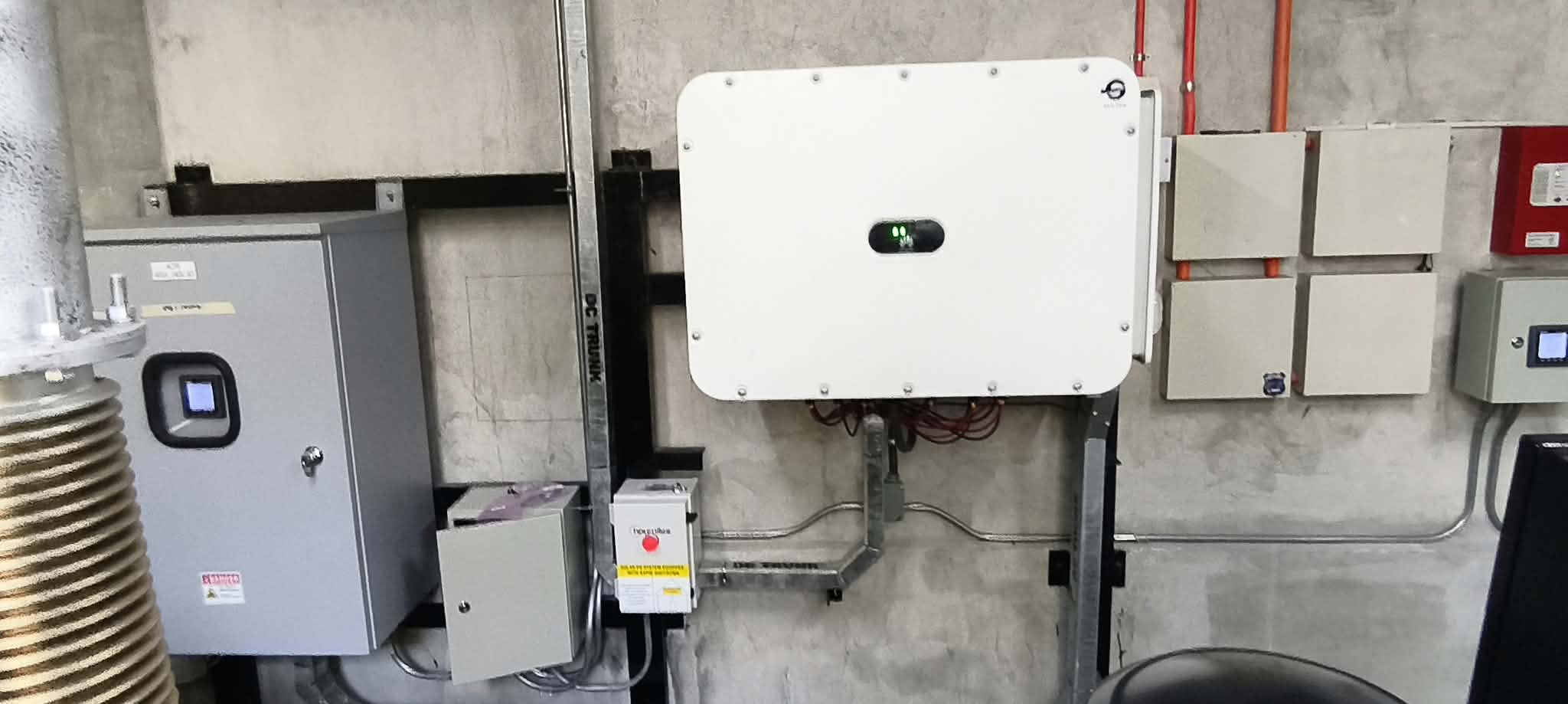 Several inverters and electrical enclosures mounted on a wall.