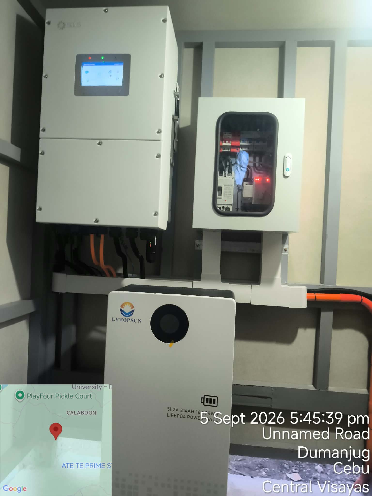 Indoor solar inverter mounted above a battery storage unit.