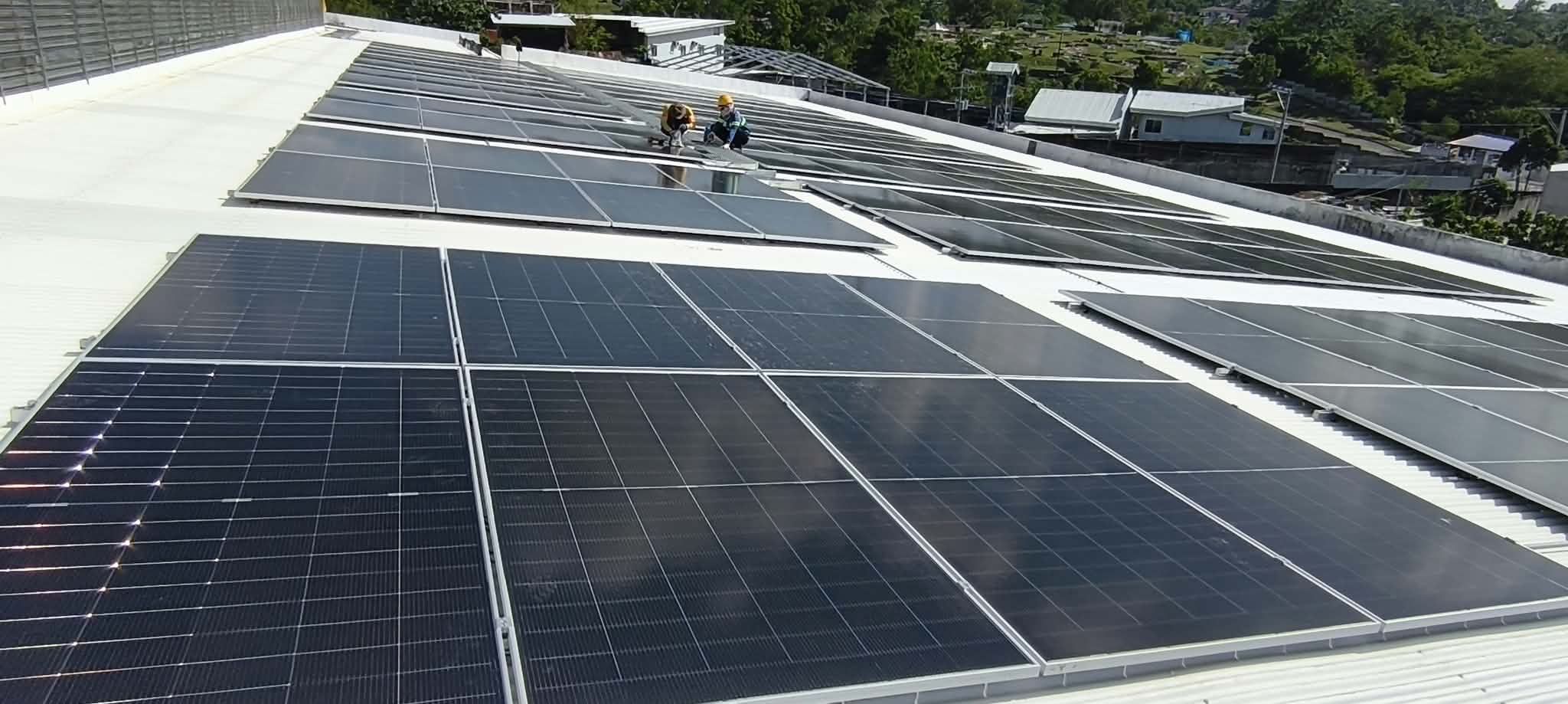 Solar modules arranged across a rooftop.